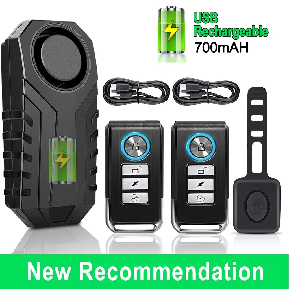 Motorcycle alarm system with remote controls and USB cable on a white background