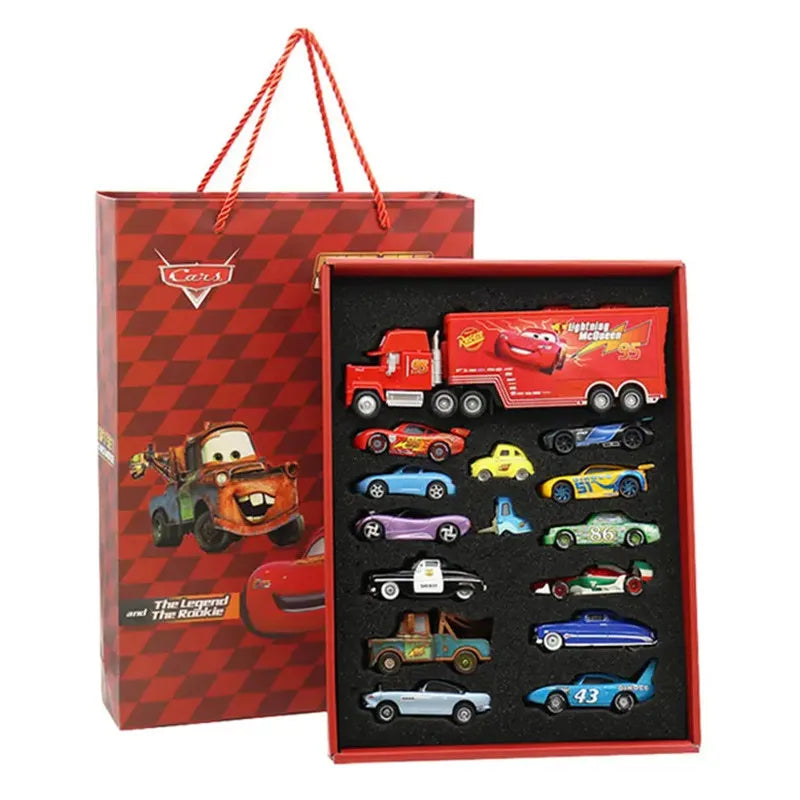 Set of toy cars in a red gift box with a checkered pattern, featuring a tow truck and various other cars.