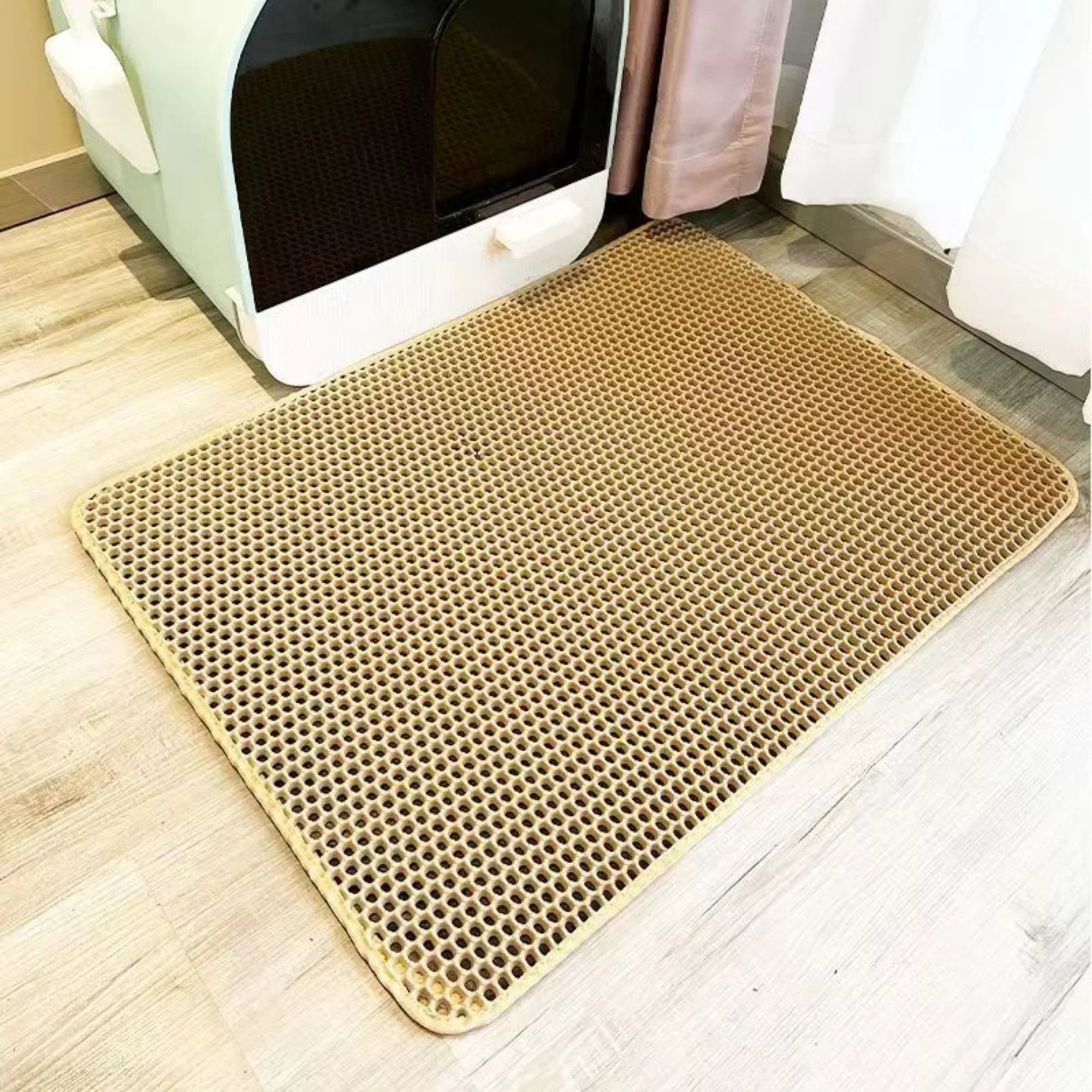 Beige doormat with honeycomb pattern on a wooden floor