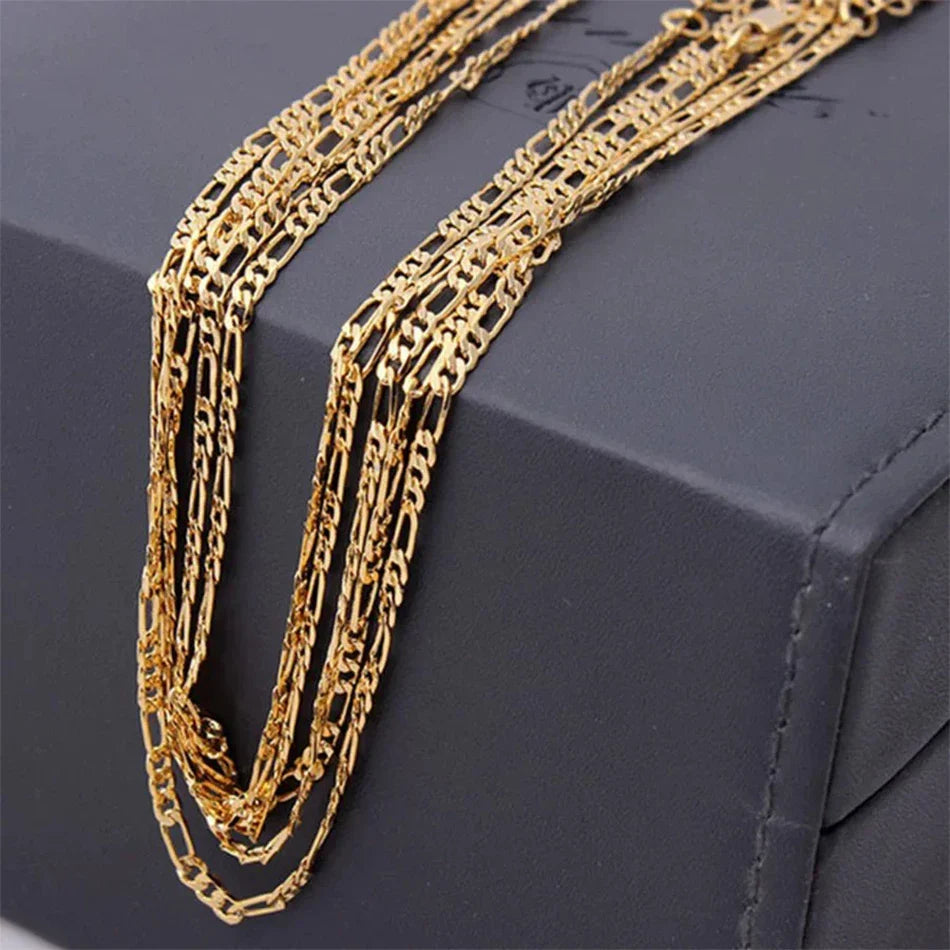 Gold chain necklace on a dark jewelry box