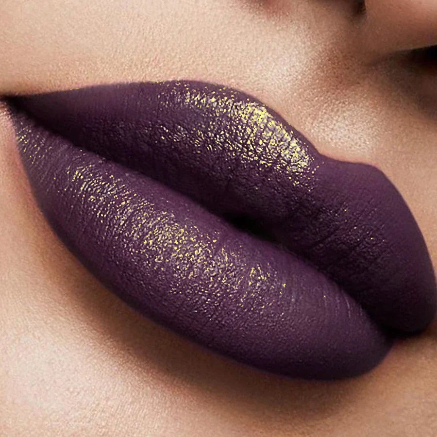 Close-up of a person wearing purple lipstick with a metallic sheen.
