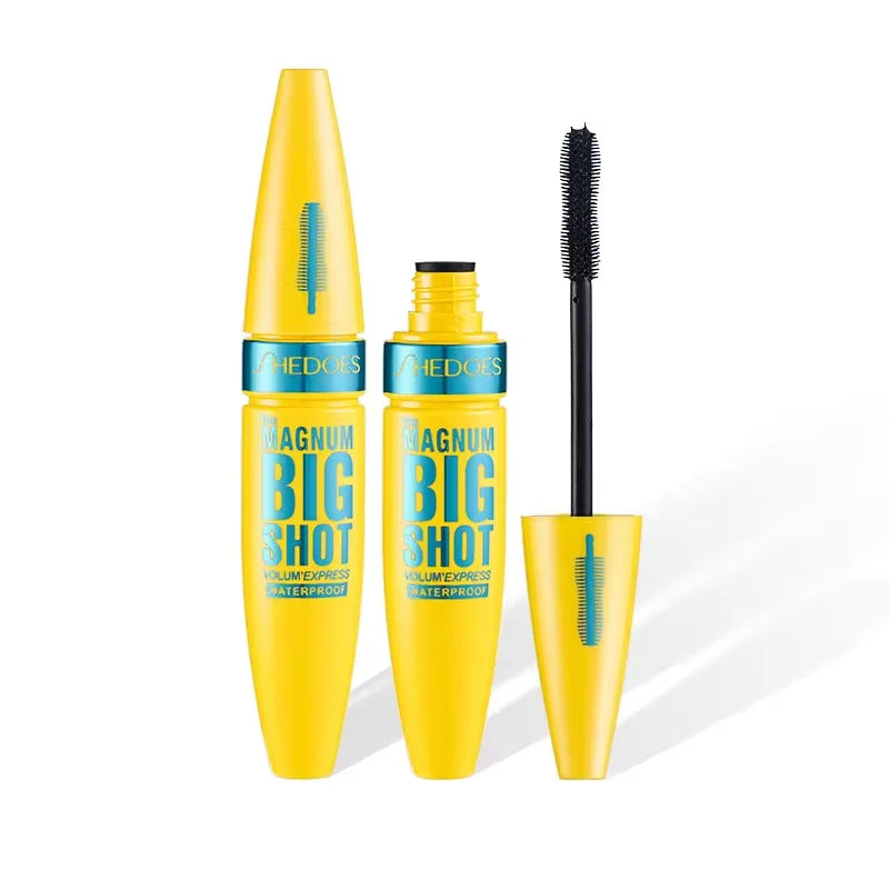 Yellow mascara with black brush on a white background