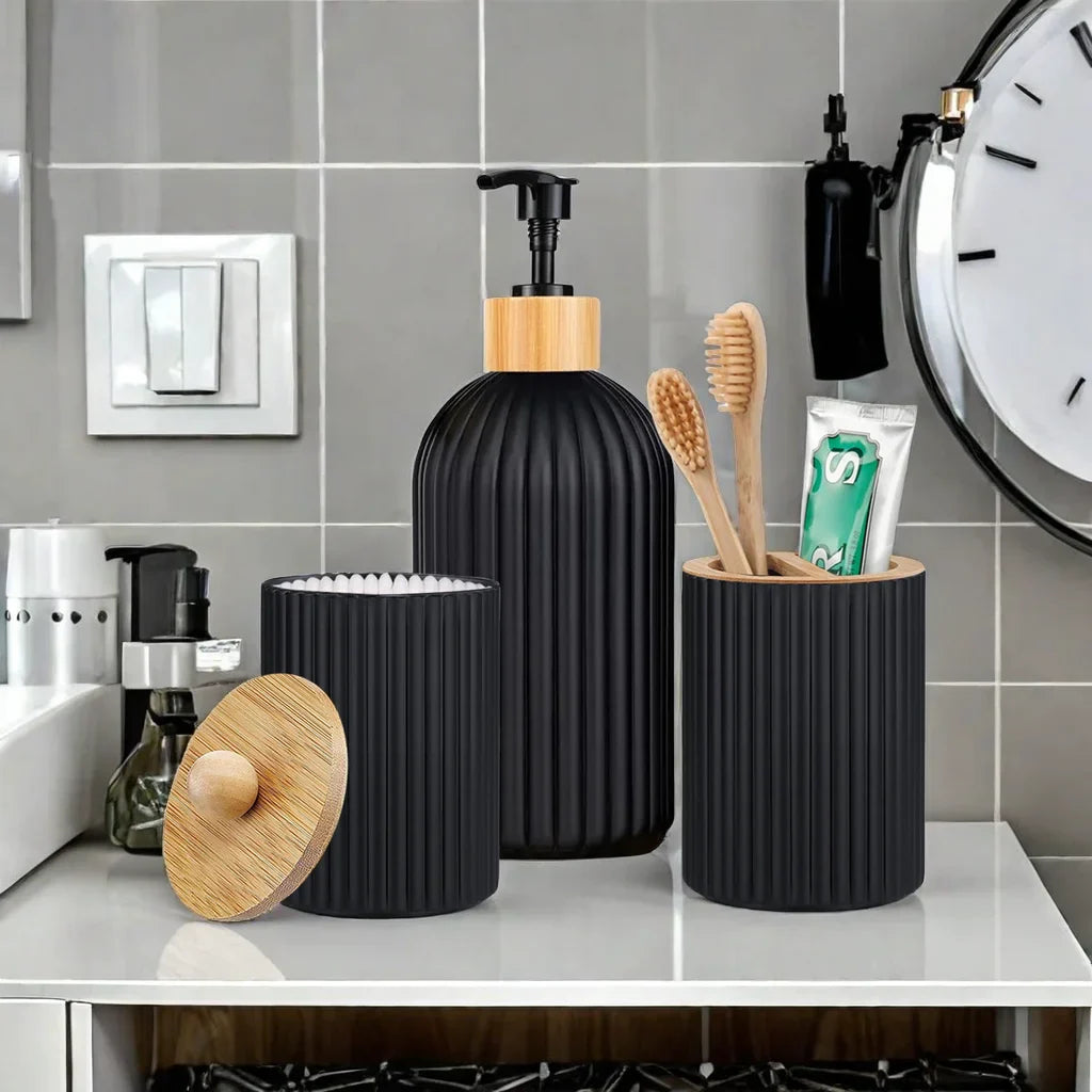 Bathroom counter with black ribbed soap dispenser, toothbrush holder, and containers.