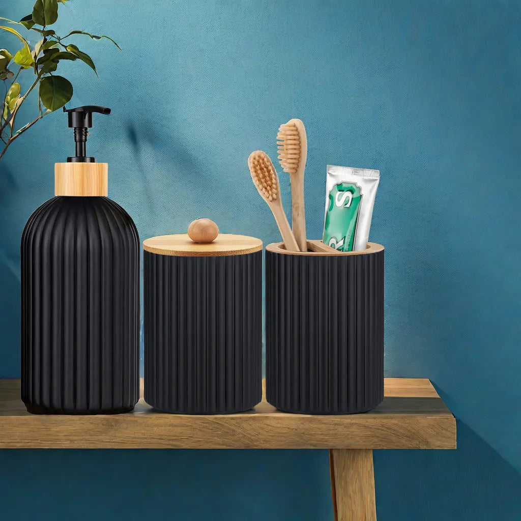 Black ribbed containers with wooden lids on a wooden surface against a blue wall.