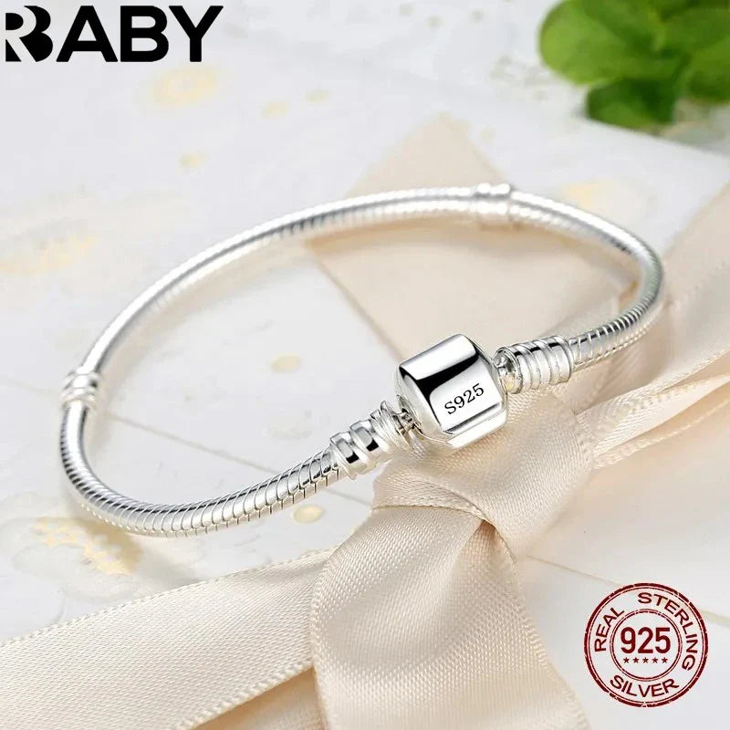 Silver bracelet with a 'Real Sterling Silver' stamp on a beige ribbon background