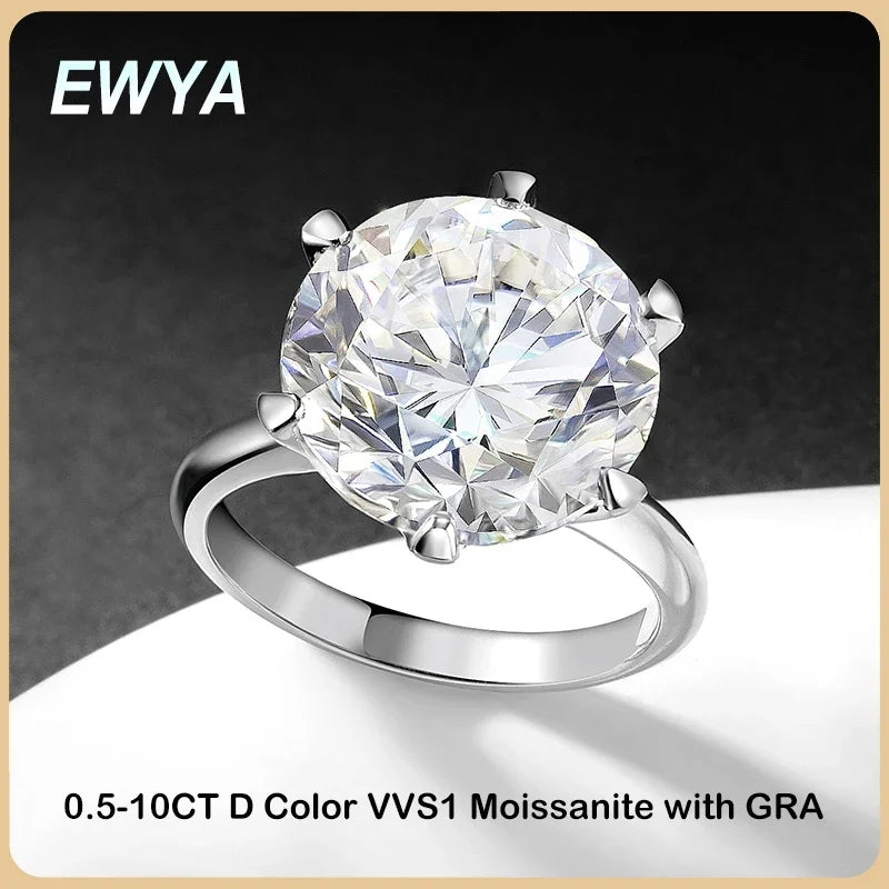 Silver ring with a large gemstone on a dark background, featuring the brand 'EWYA'.