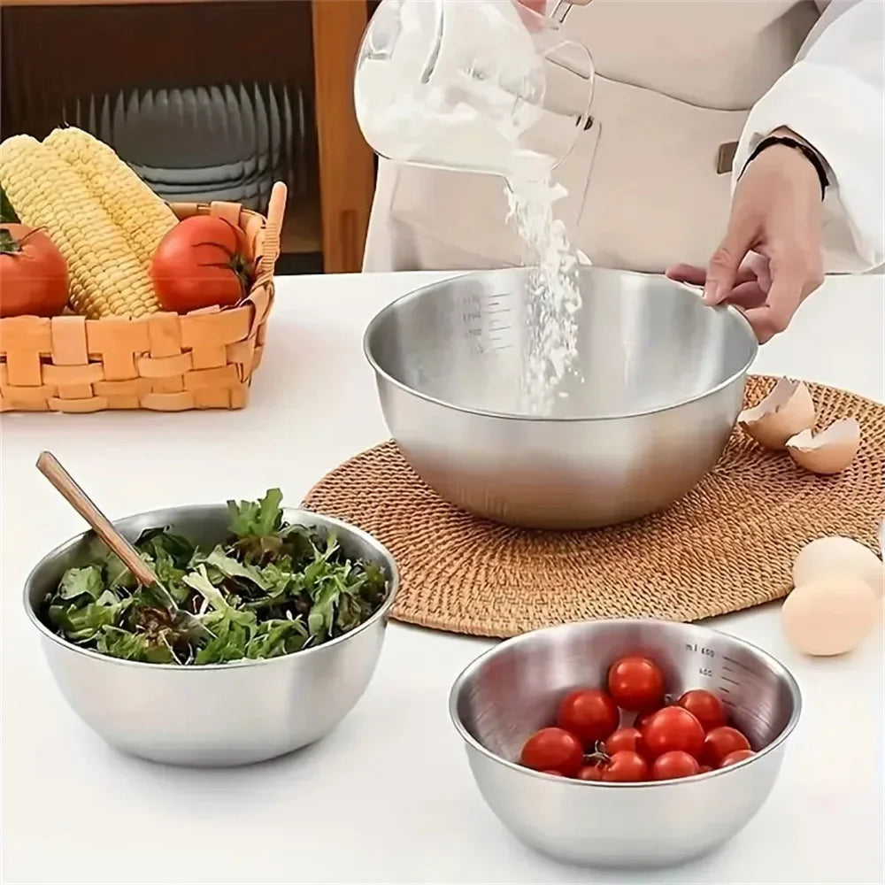Person preparing food in a kitchen with stainless steel bowls and ingredients.