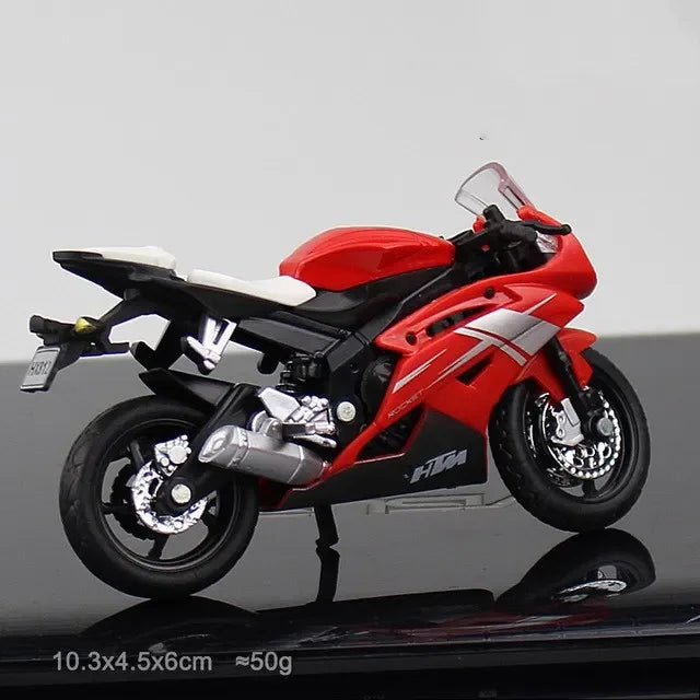 Red motorcycle model on a reflective surface with a gray background