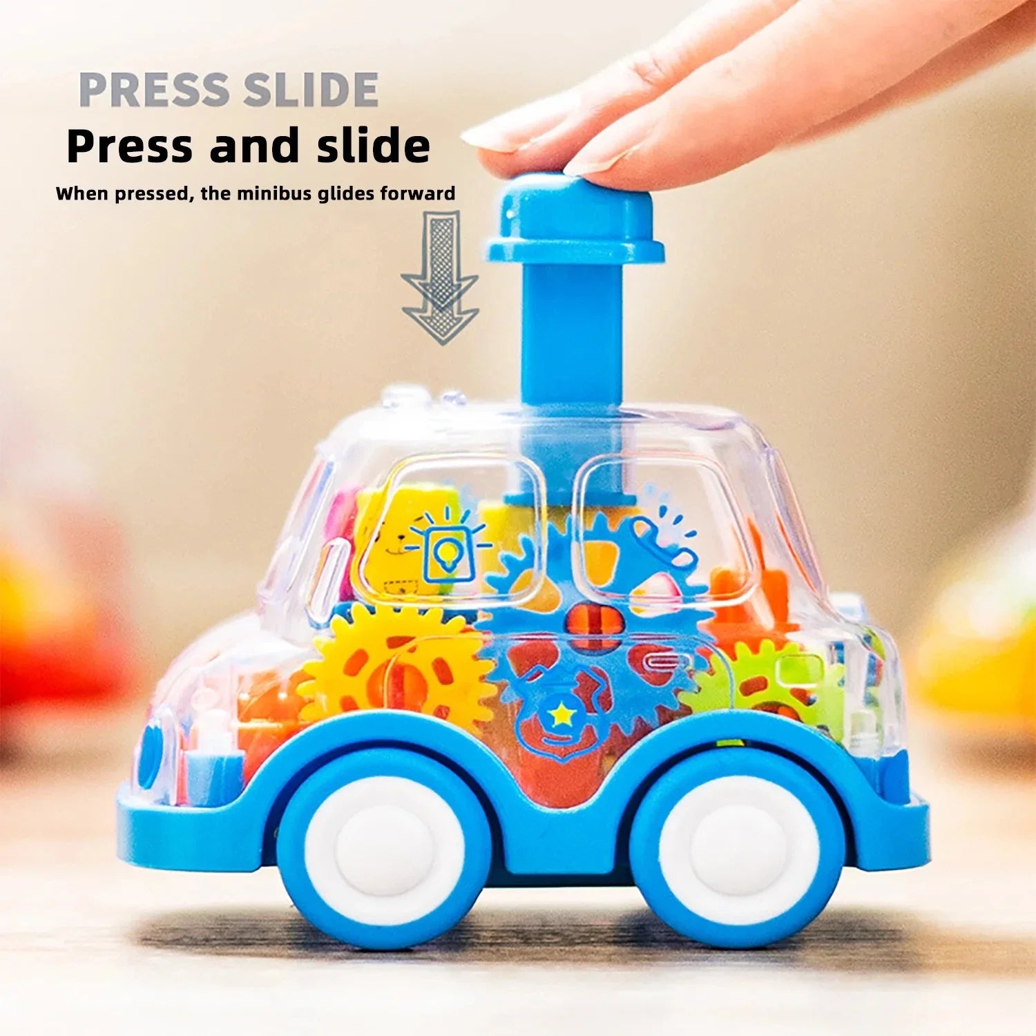 Toy vehicle with colorful gears and a hand pressing a blue lever on a blurred background