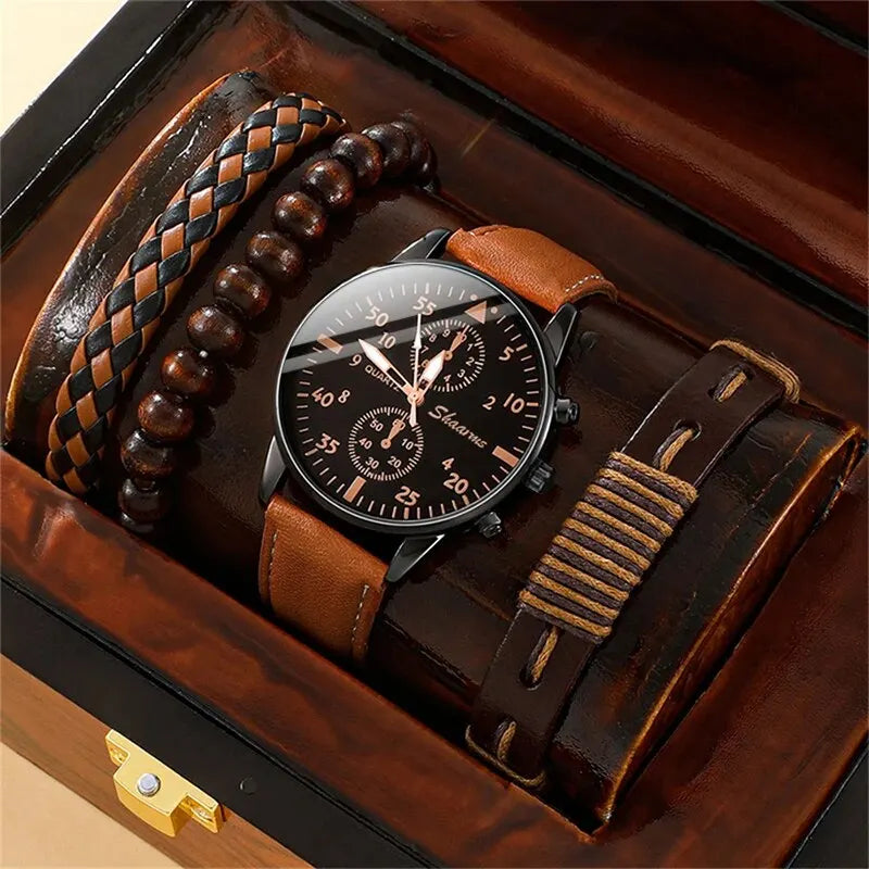 Watch with brown leather strap and wooden box in the background