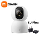 Xiaomi smart camera with EU plug adapter on a white background
